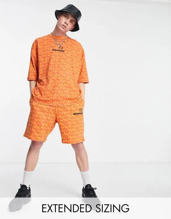 ASOS Daysocial relaxed shorts with all over logo print in orange - part of a set
