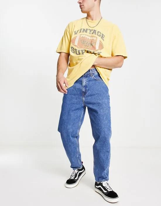 easton loose tapered fit jeans in mid wash