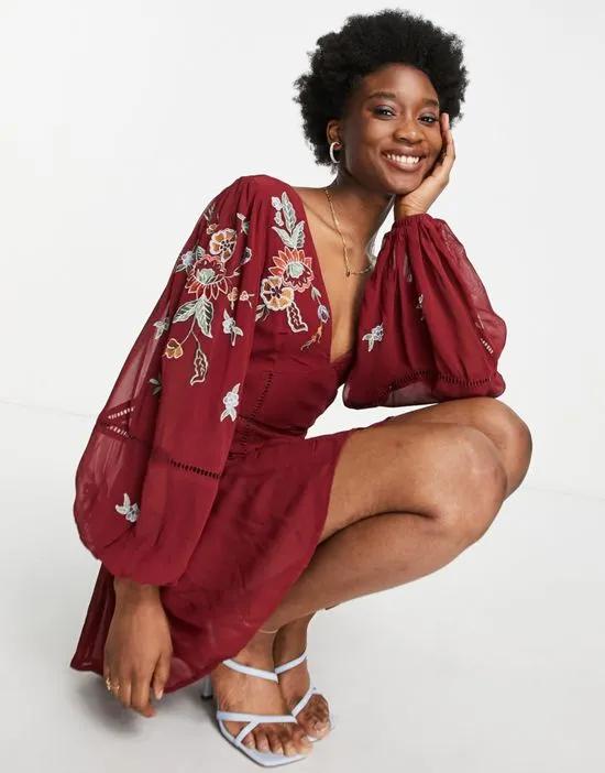 embroidered plunge neck smock romper in berry