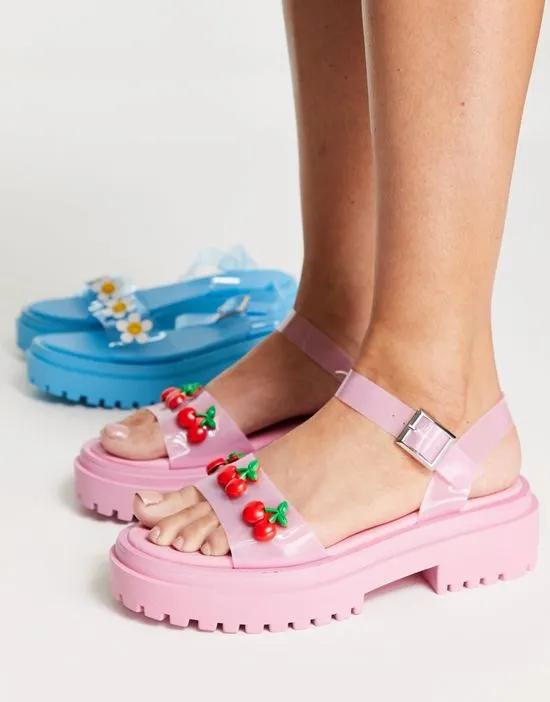 Exclusive flat sandals with cherries in pink vinyl