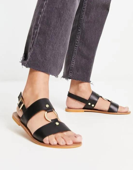 Fancy leather ring and stud detail flat sandals in black