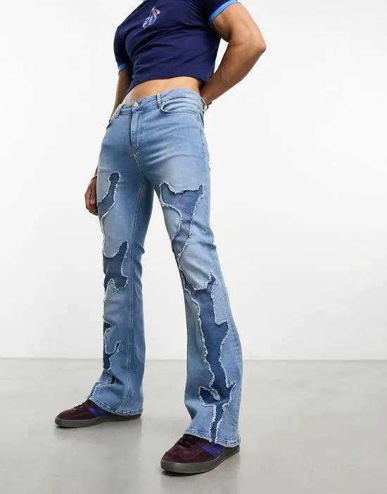 flare jeans with raw edges in mid blue