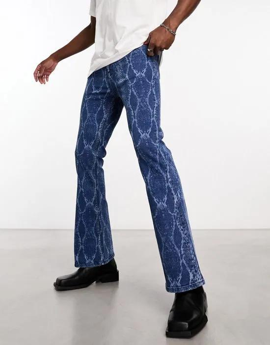 flared jeans with snake print in mid wash blue