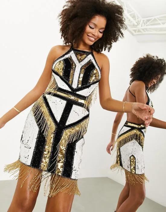 graphic sequin placement fringe mini dress in black and gold