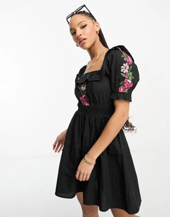 lace insert mini dress in black with floral cross-stitch embroidery