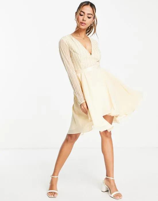 linear embellished bodice mini dress with wrap skirt in cream