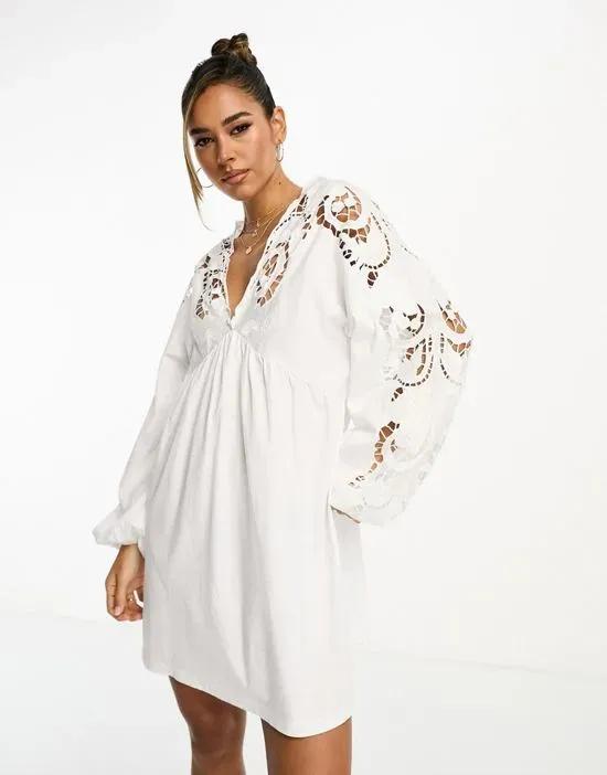 long sleeve mini smock dress with cut out embroidery in white