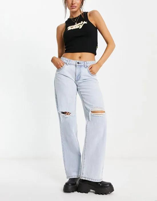 low rise straight leg jeans with ripped knees in bleach wash