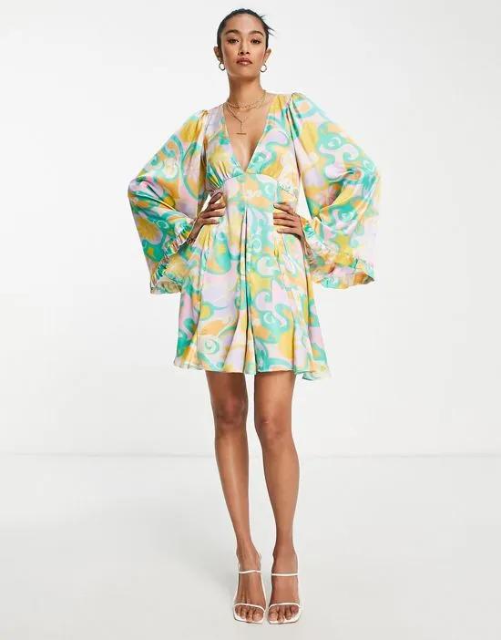 mini smock dress with godets and flared sleeves in bright abstract floral