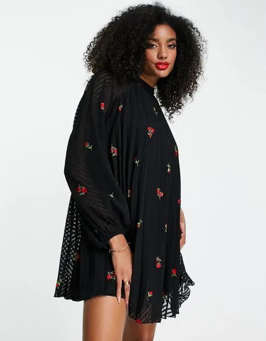 pleated trapeze mini dress with all over embroidery in black