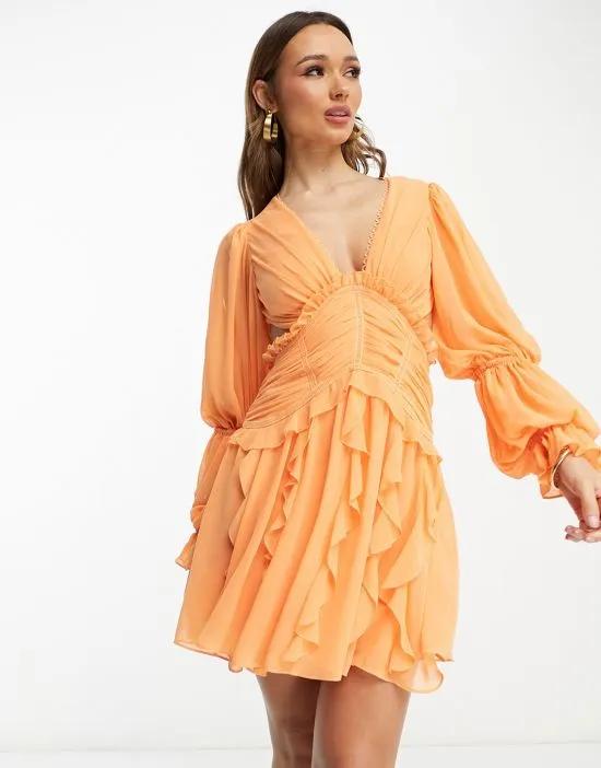 Ruched waist plunge mini dress with ruffle skirt and open back detail in orange