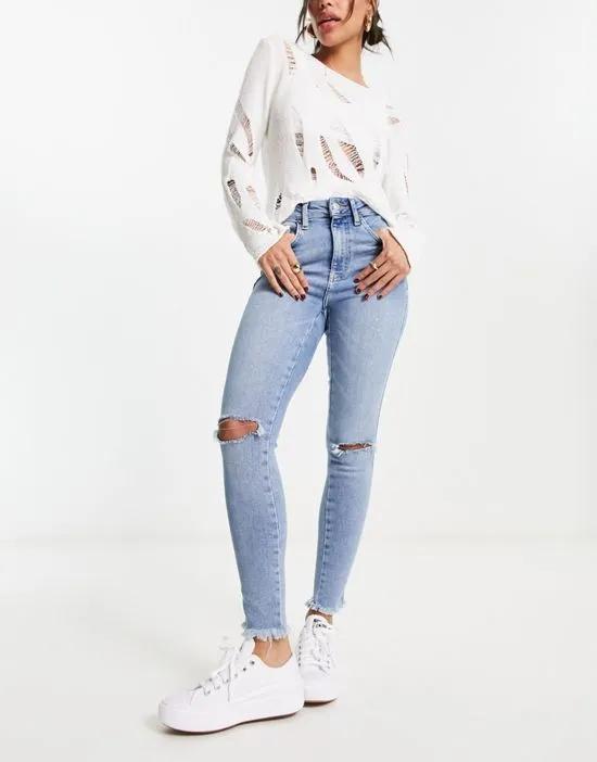 skinny jeans with rip details in light blue