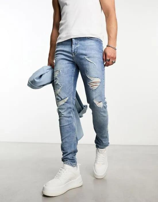 skinny jeans with rips in light wash blue