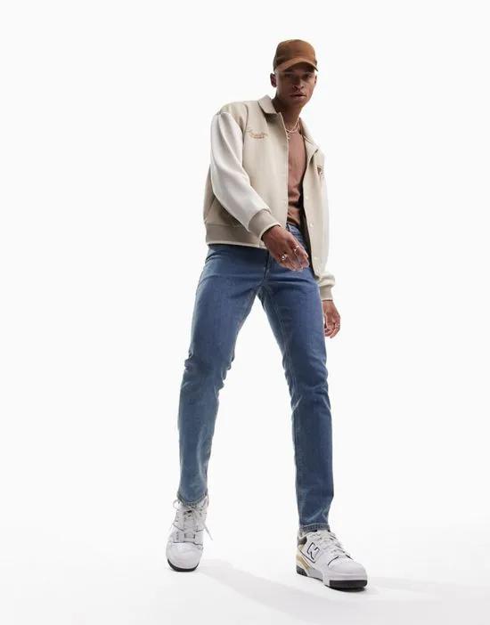 slim jeans in flat mid wash blue