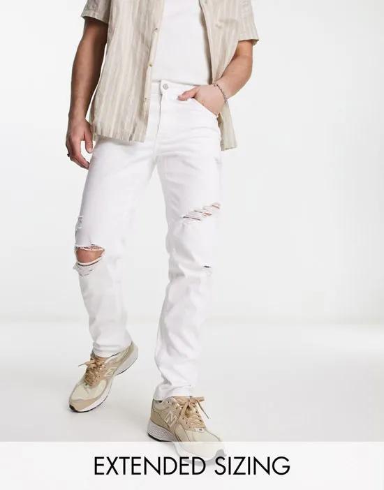 slim jeans with heavy rips in white