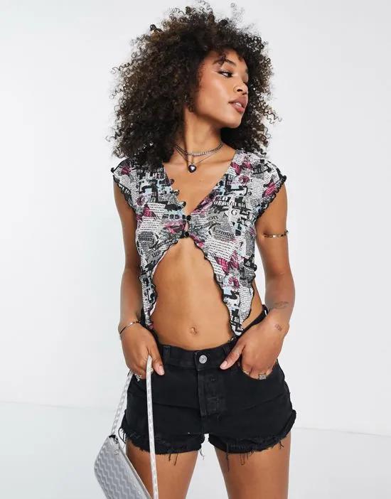slinky mesh top with pointed lettuce hem in butterfly and newspaper graphic print