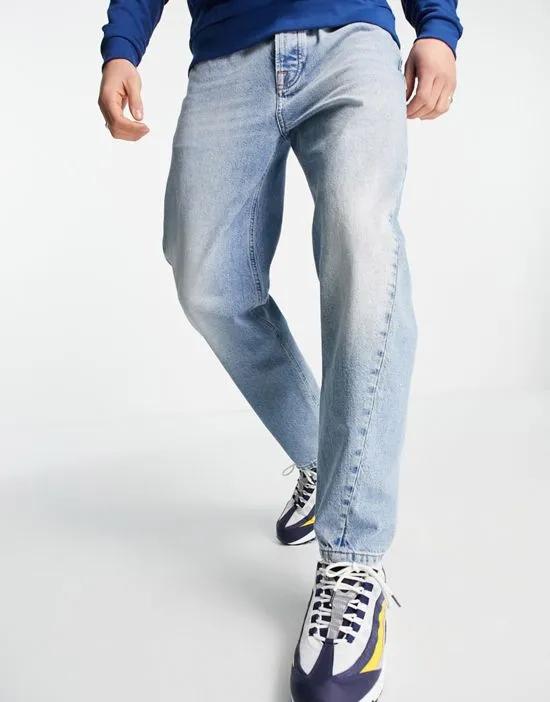 tapered curved leg jeans in light wash blue