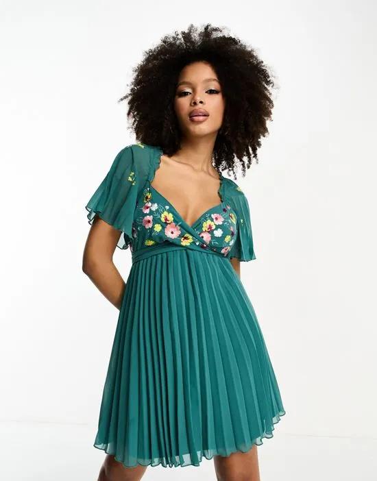 tie back angel sleeve pleated mini dress with embroidered bust in teal