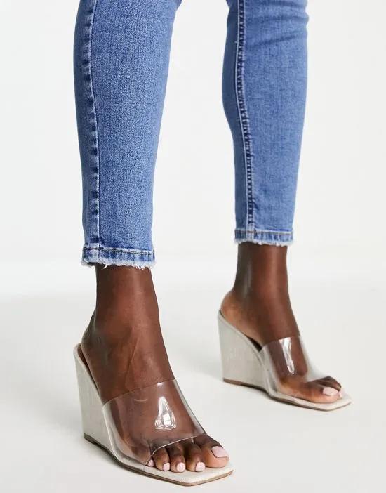 True high wedge mules in clear and natural