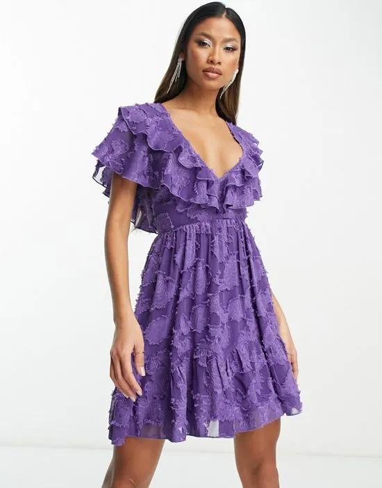 v front v back ruffle mini dress with flutter sleeve and tie belt in textured jacquard in purple