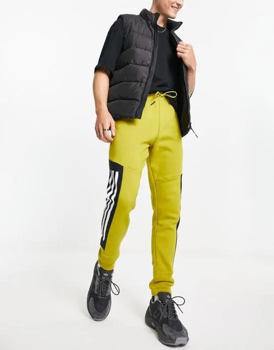 adidas Sportstyle Future Icons 3 stripe sweatpants in green