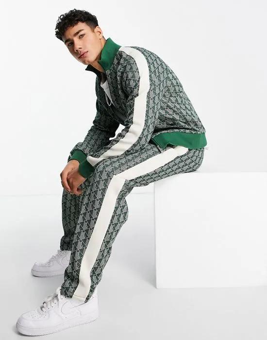 all-over print taped track pants in green