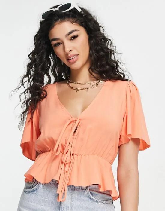 angel sleeve with double tie front tea blouse with peplum hem in bright peach