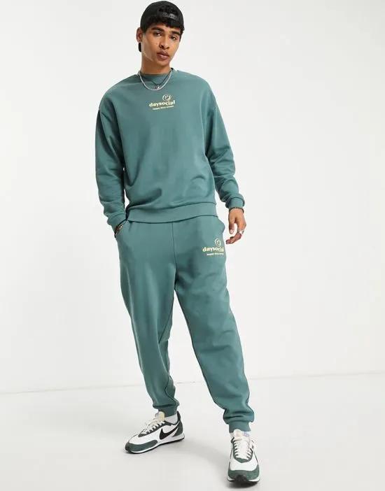 ASOS Daysocial oversized sweatpants with logo print in teal blue - part of a set