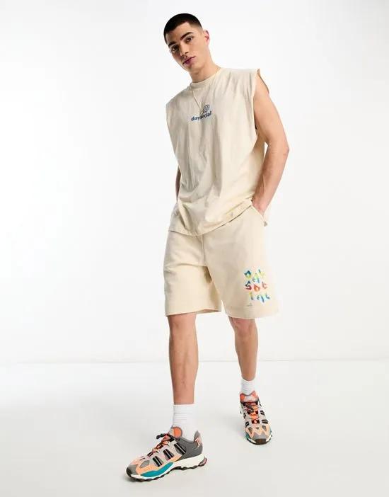 ASOS Daysocial relaxed shorts with multi colored bubble logo in beige - part of a set