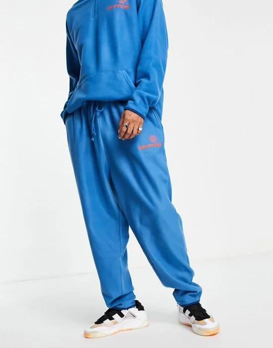 ASOS Daysocial relaxed sweatpants in polar fleece with logo print in blue - part of a set