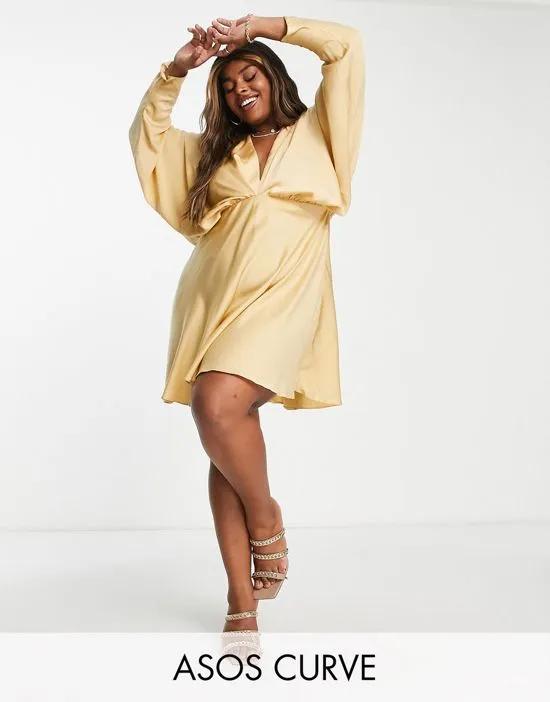 ASOS DESIGN Curve batwing satin mini dress with bias cut skirt and tie back in gold