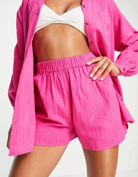 ASOS DESIGN textured beach shorts in pink