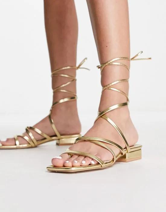Bebo vinny strappy tie leg flat sandals in gold