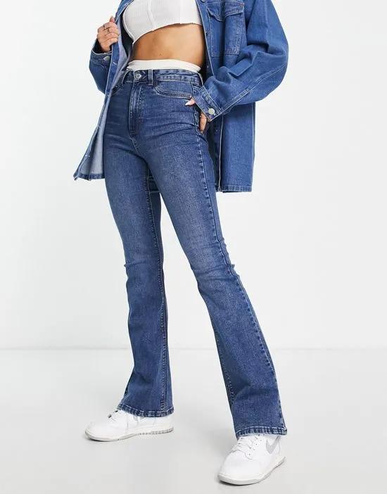 bootcut flared high rise jeans in mid blue wash