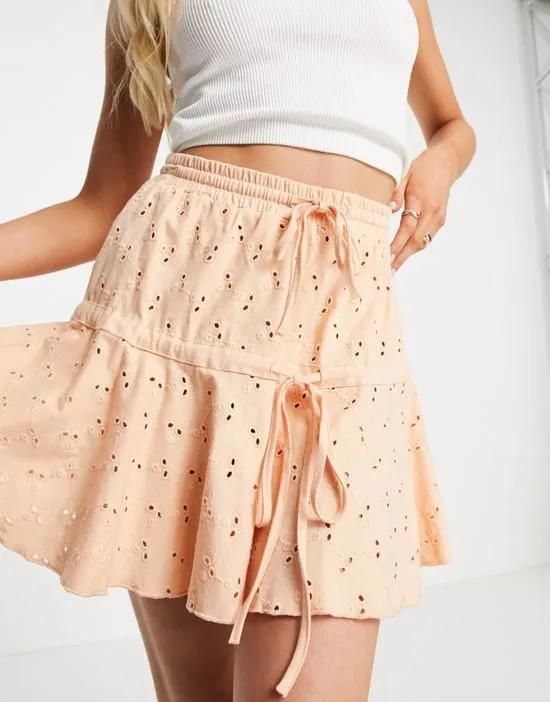 broderie tiered mini skirt with tie detail in apricot