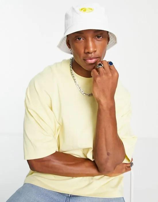 bucket hat in white with lemon embroidery