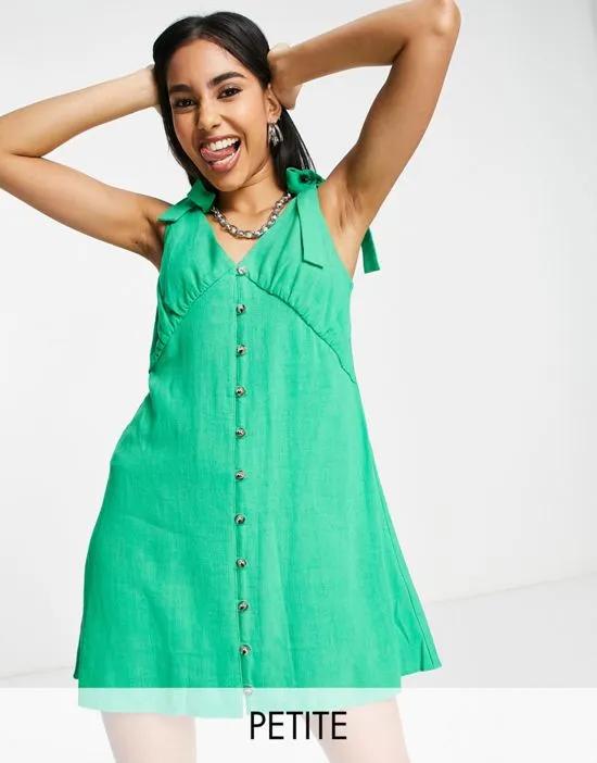 button through flippy mini dress in linen in green