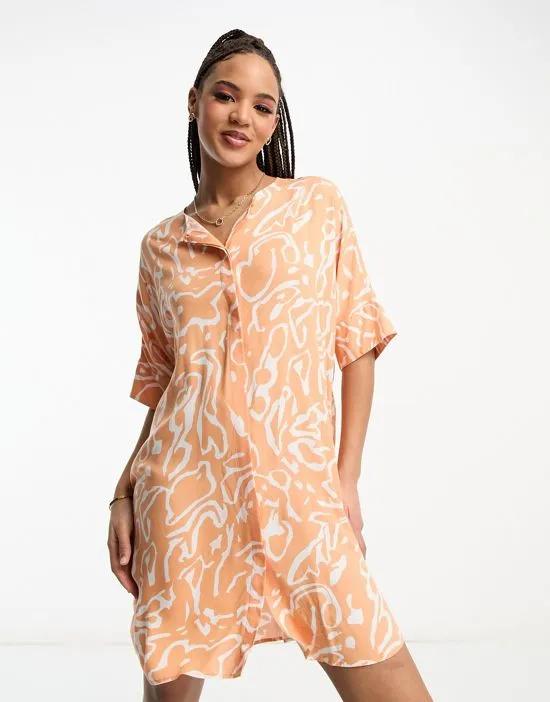 button through mini dress in orange scribble