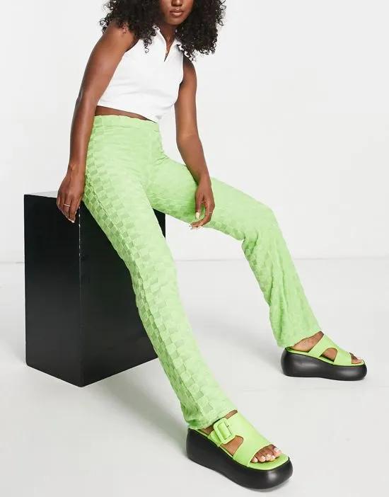 checkerboard print devore flare pants in green - part of a set