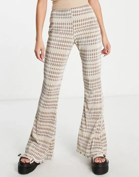 checkerboard print plisse flare pants in beige - part of a set
