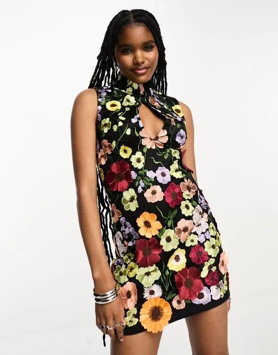 Cleo high neck sleeveless mini dress in black based floral embroidery