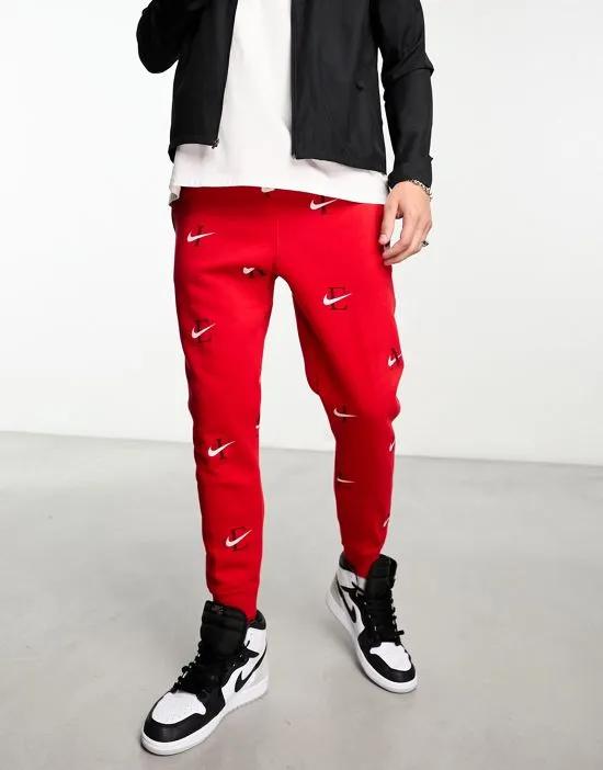 Club Fleece all over print joggers in red