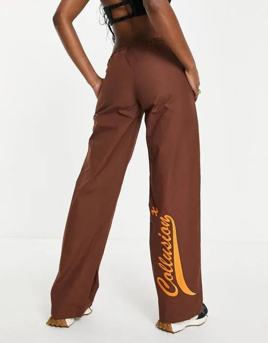 COLLUSION low rise straight leg parachute pants with embroidered branding in brown