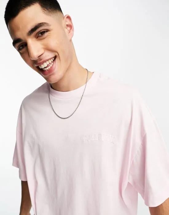 COLLUSION Unisex varsity embroidered logo T-shirt in light pink