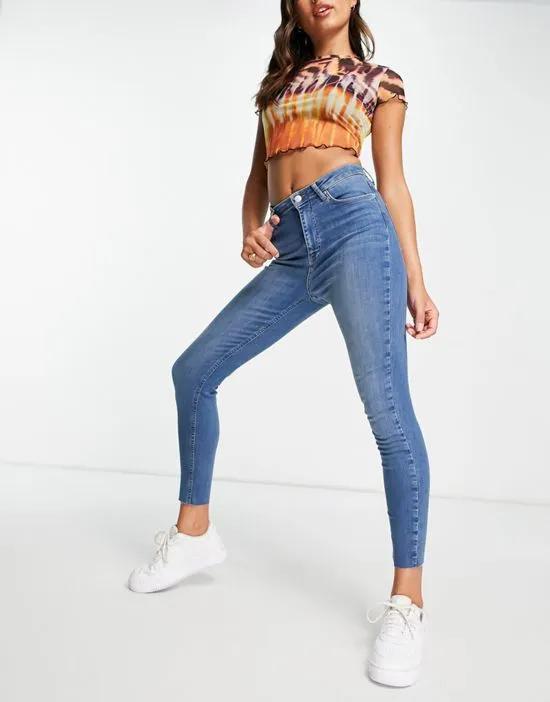 cotton skinny highwaist jeans with raw hem in mid blue