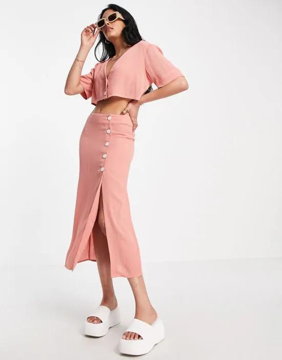 crinkle button side midi skirt in pink - part of a set