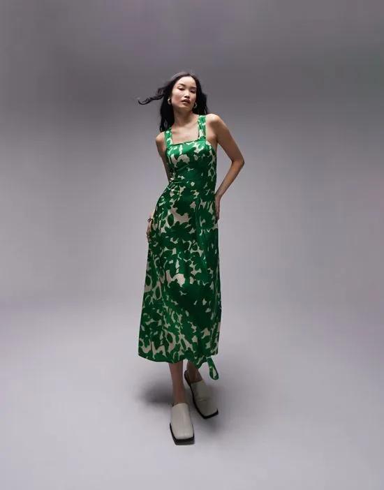 cross back midi pinny with pockets in green floral print