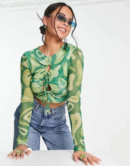 cut out mesh crop top in green abstract graphic