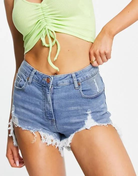 denim shorts with distressed hem in mid blue