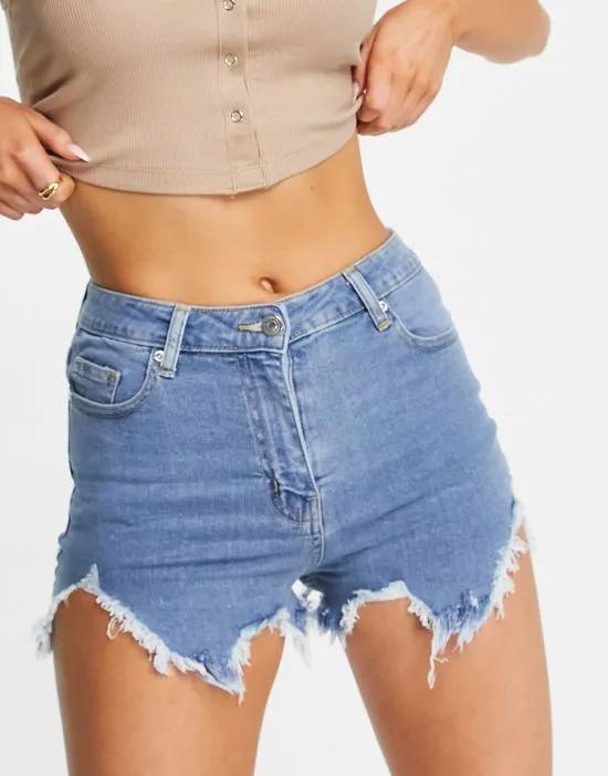 distressed denim shorts with rips in mid blue